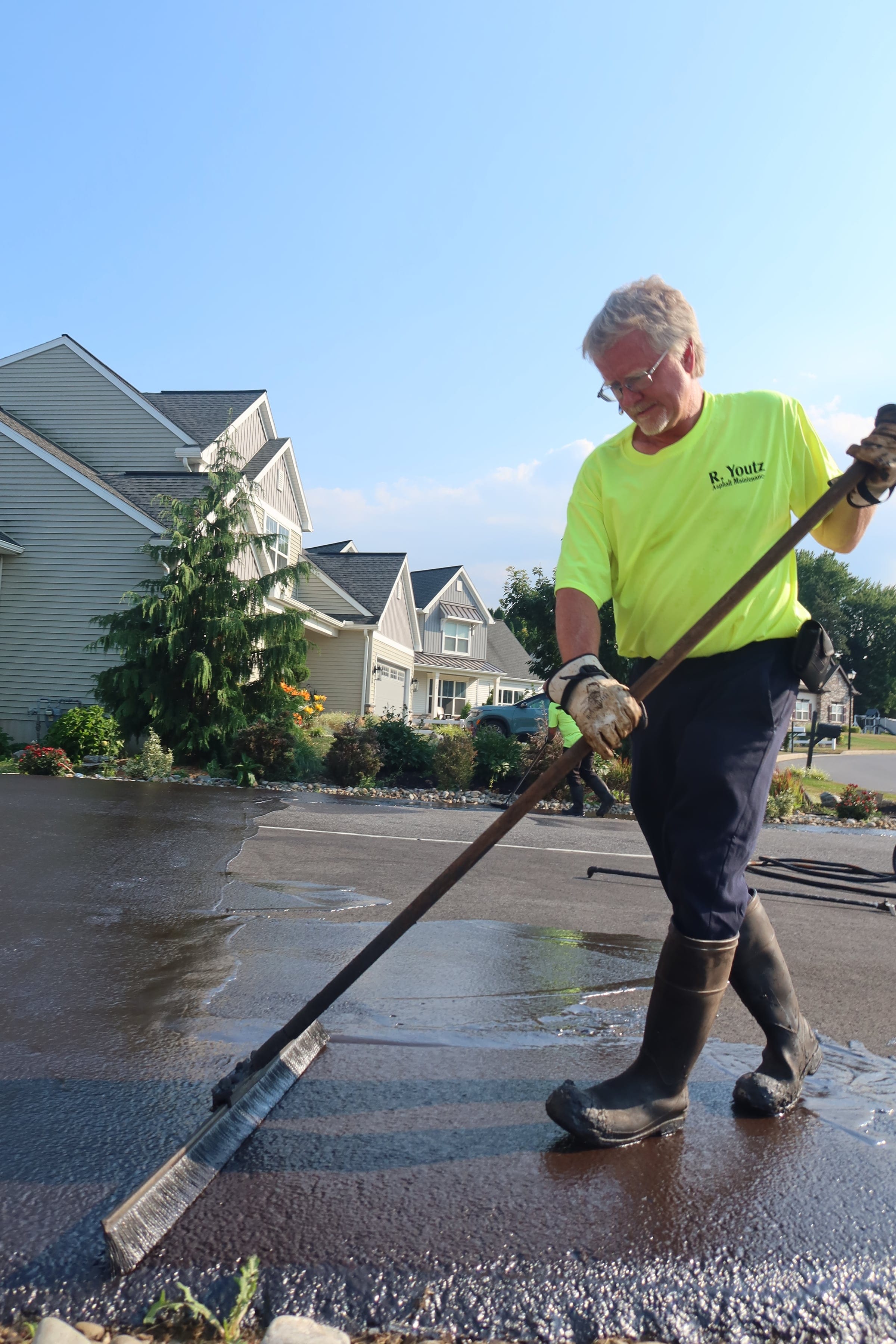 Brush sealcoating in neighborhood — R. Youtz Asphalt Maintenance
