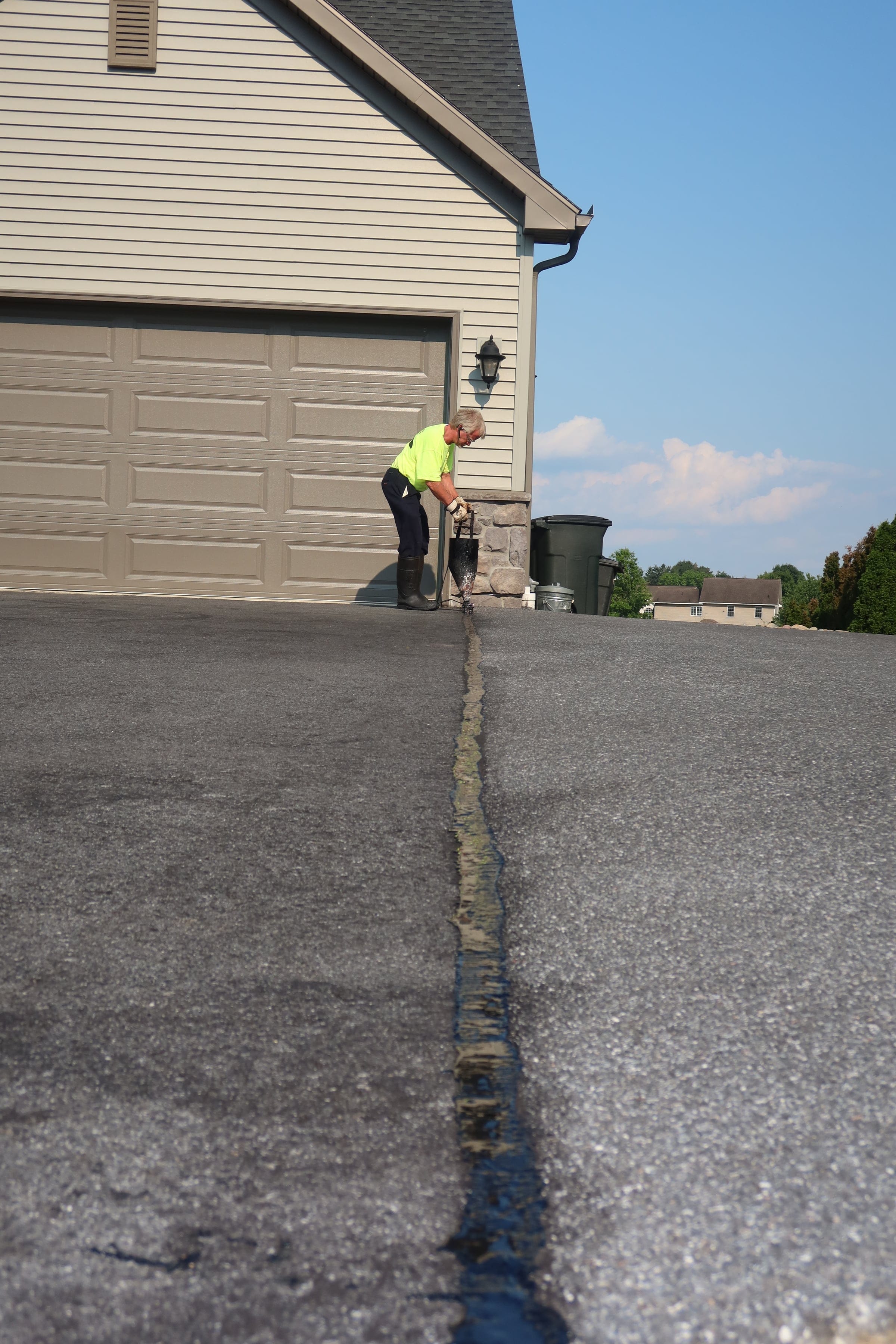Crack filling with pour pot — R. Youtz Asphalt Maintenance