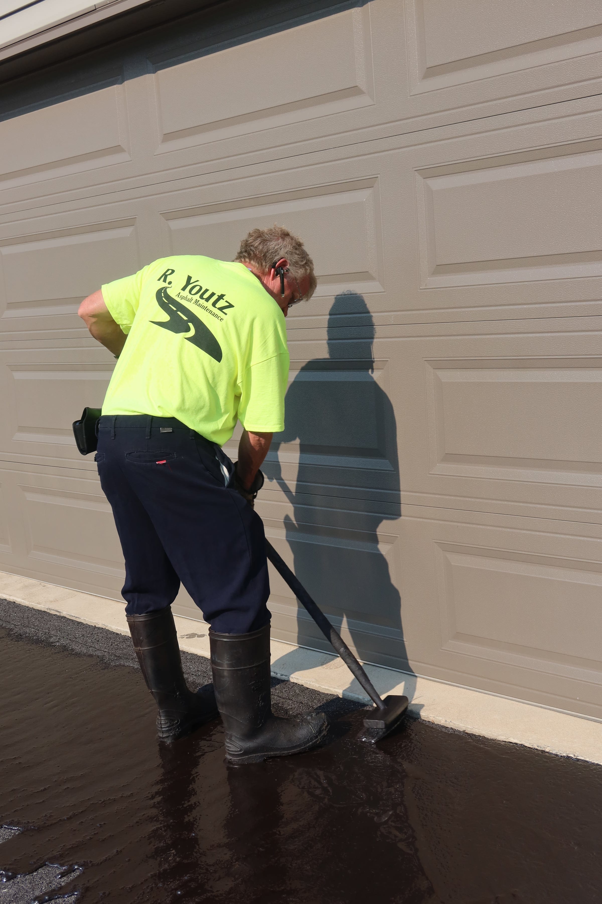 Hand-brushed garage edge — R. Youtz Asphalt Maintenance