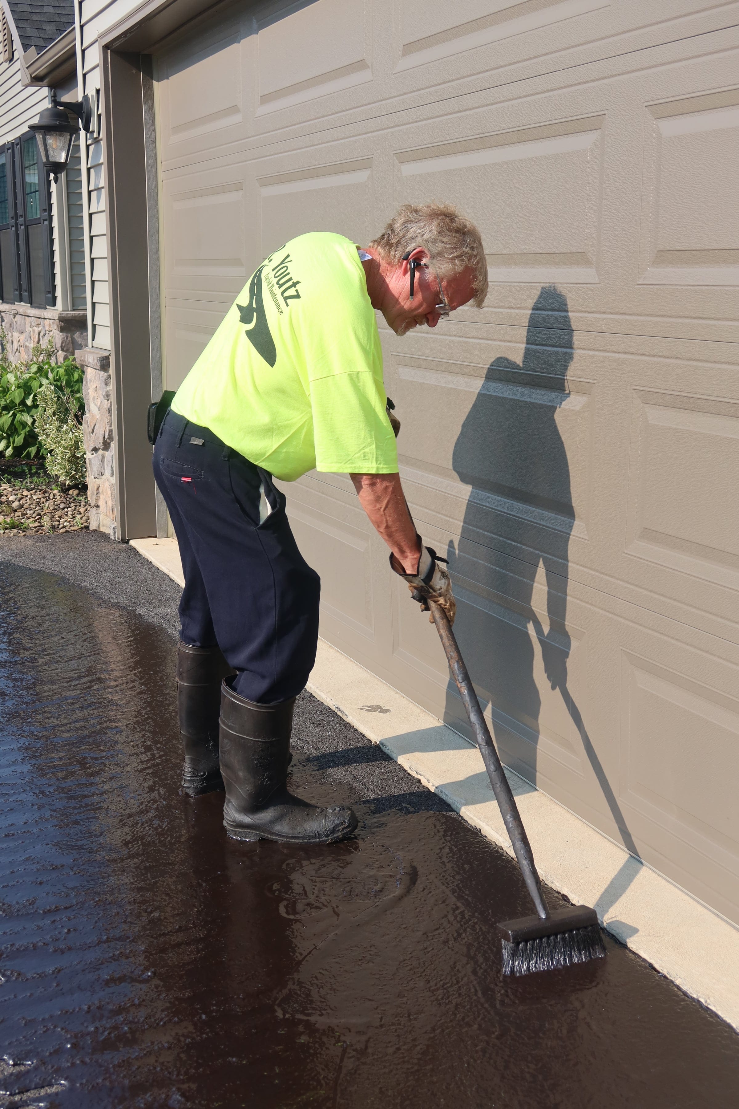 Manual brush sealcoating — R. Youtz Asphalt Maintenance